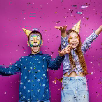 portrait-positive-cheerful-little-girl-boy-have-fun-isolated-violet-color-wall-serpentine-flying
