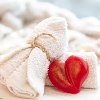 spa-composition-with-heart-shaped-soap-towel-close-up spa-composition-with-heart-shaped-soap-towel-close-up